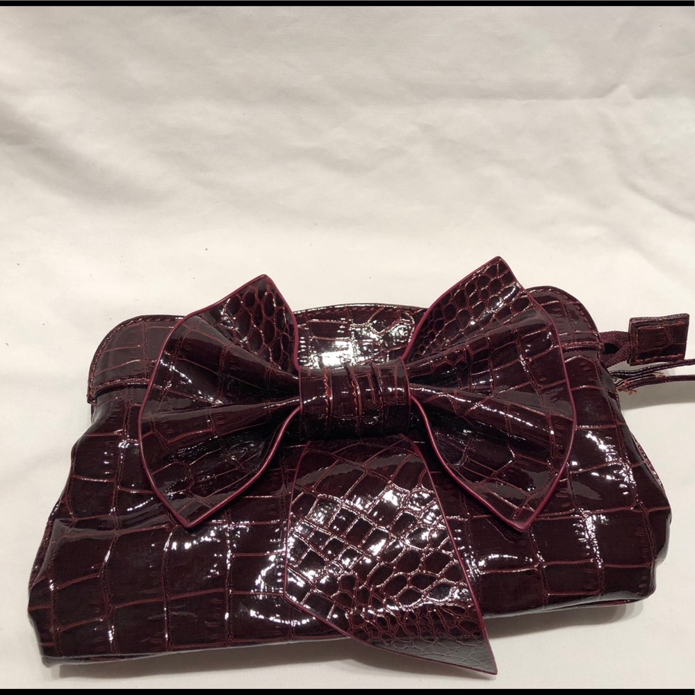 Burgundy shiny vinyl-like wristlet with strap